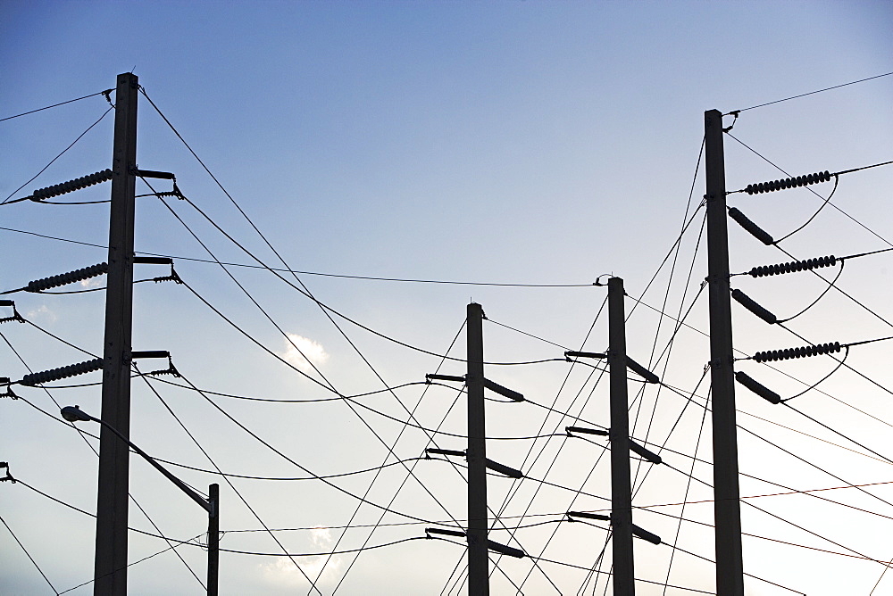 Low angle view of power lines on poles