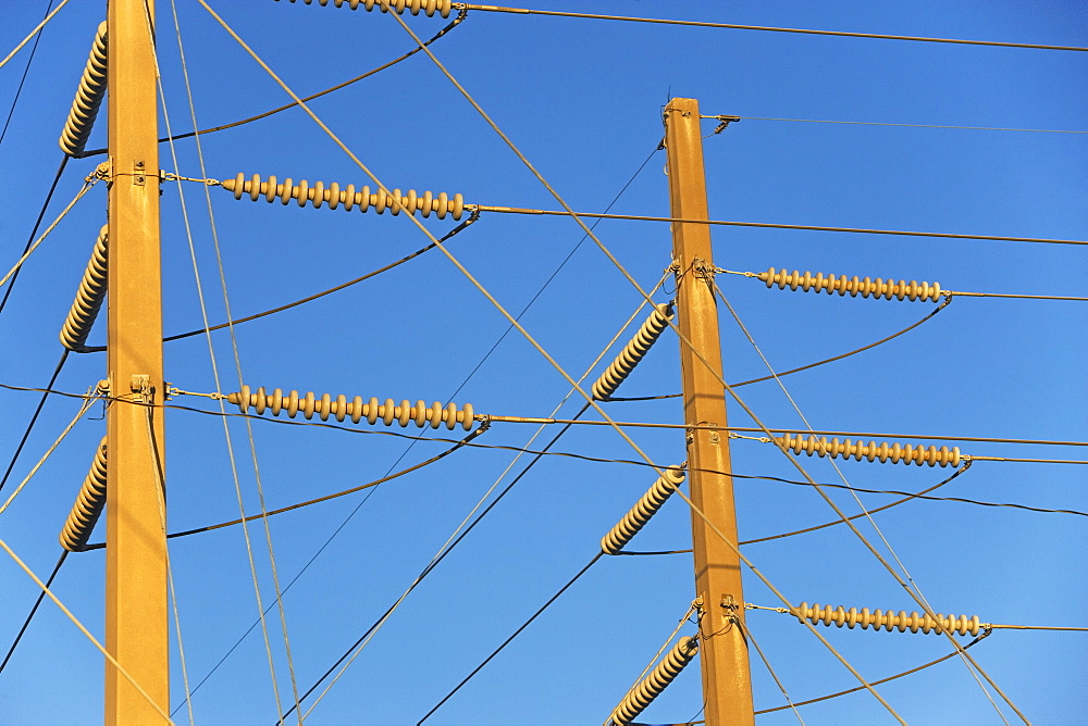 Low angle view of power lines on poles