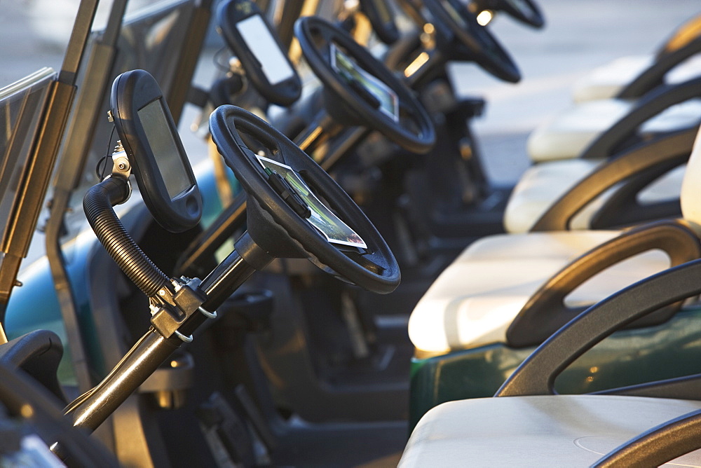 Close up of row of golf carts