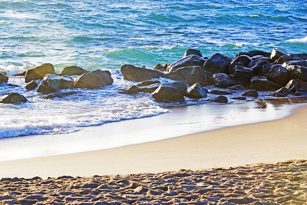 Rocks in water along beach