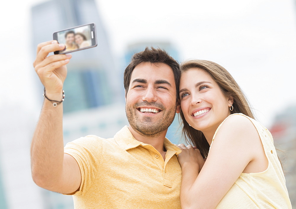 Couple taking self portrait photo with smartphone