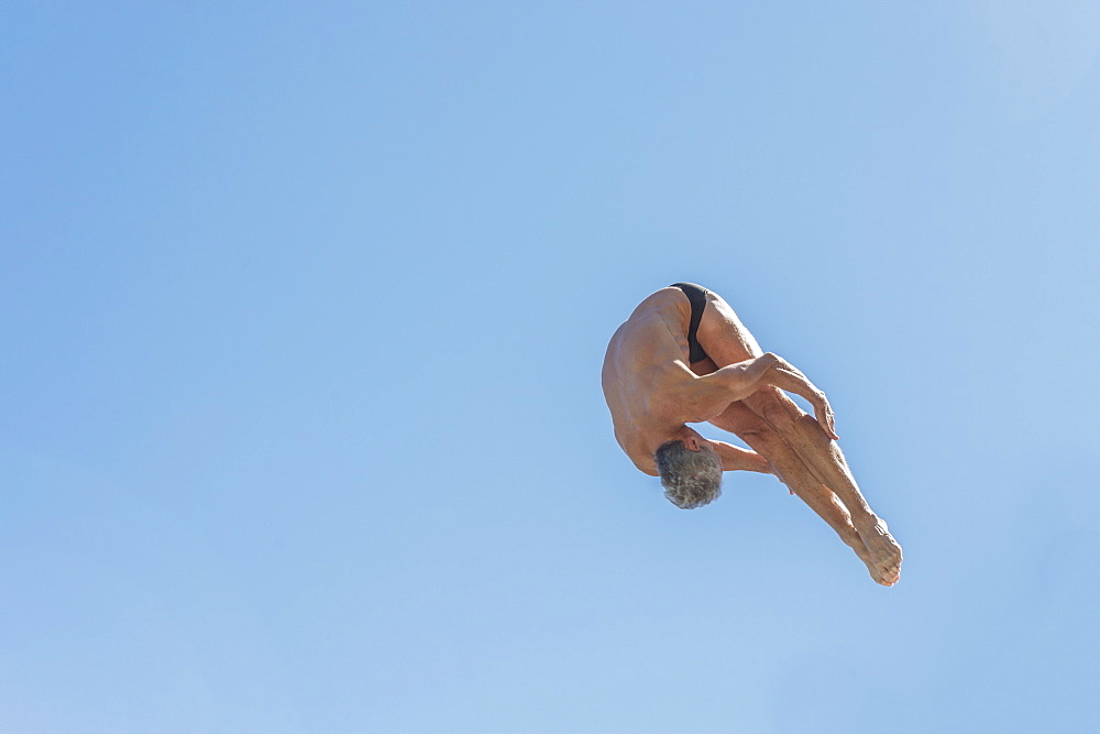 Athletic swimmer jumping