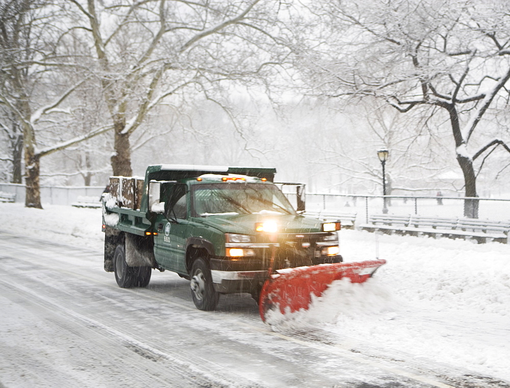 Snow plow truck clearing road