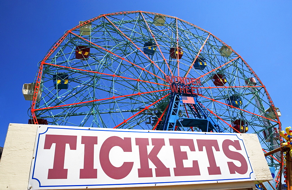 Ferris wheel and tickets sign at fairgrounds