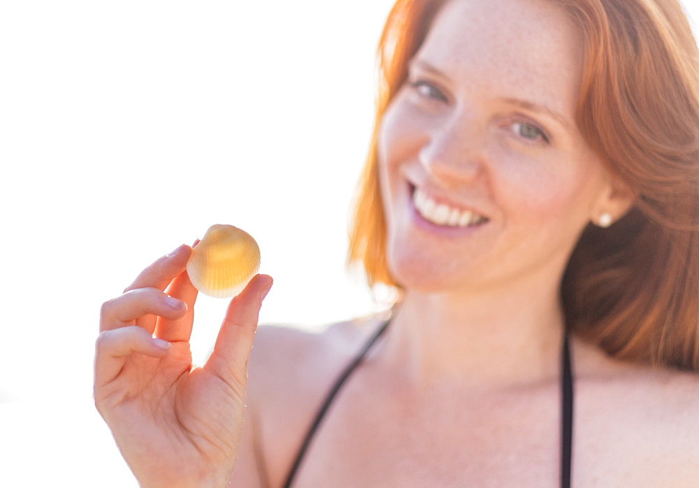 Portrait of woman holding shell