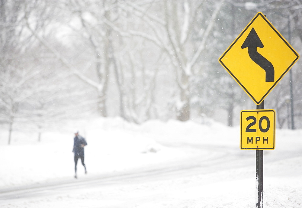 USA, New York City, speed limit and warning sign by snowy road