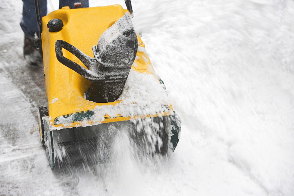 USA, New York City, machine removing snow