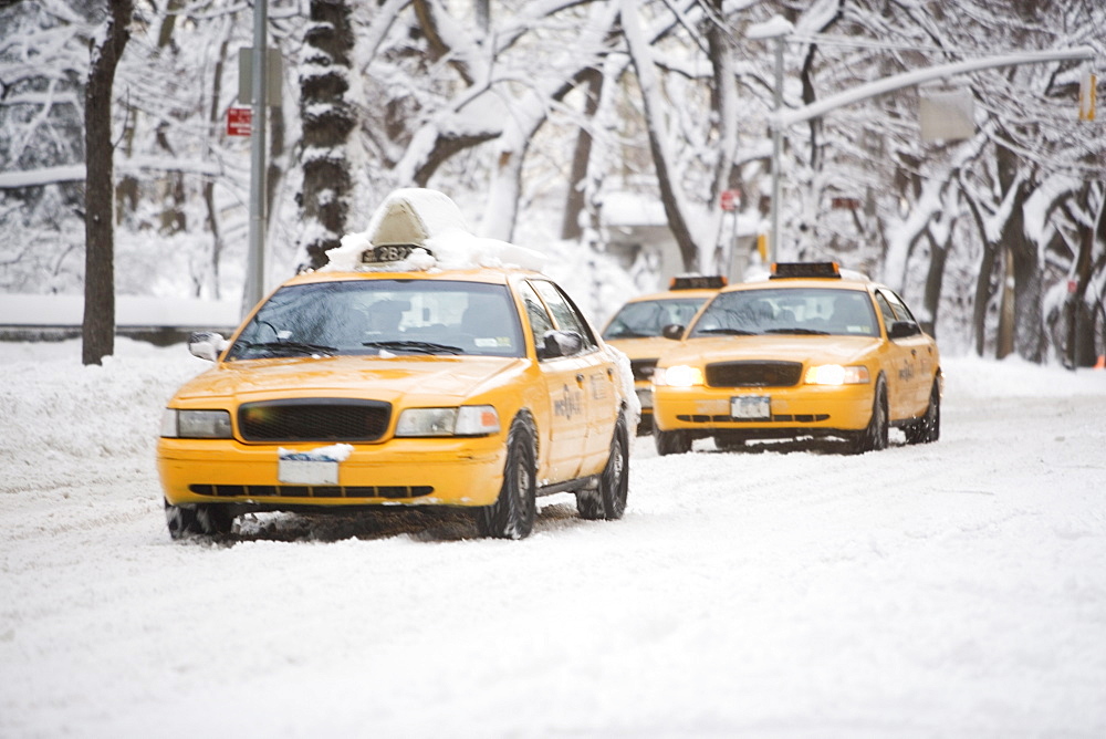 USA, New York City, yellow cabs on snowy street