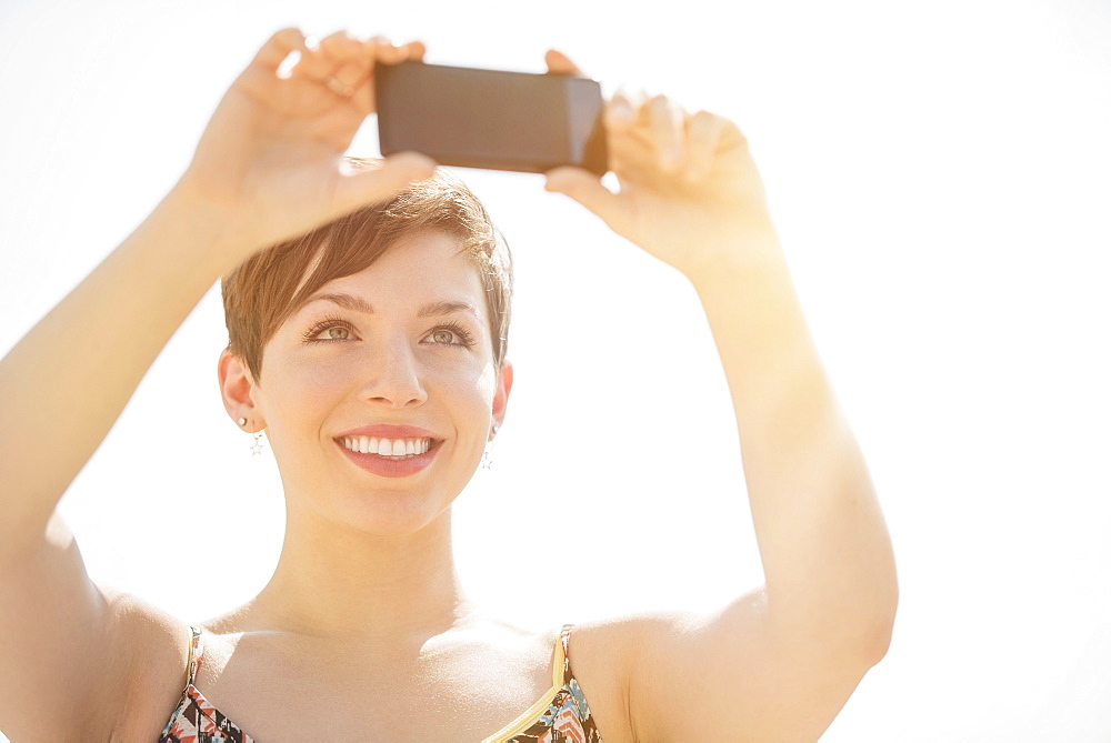 Young woman taking selfie with mobile phone