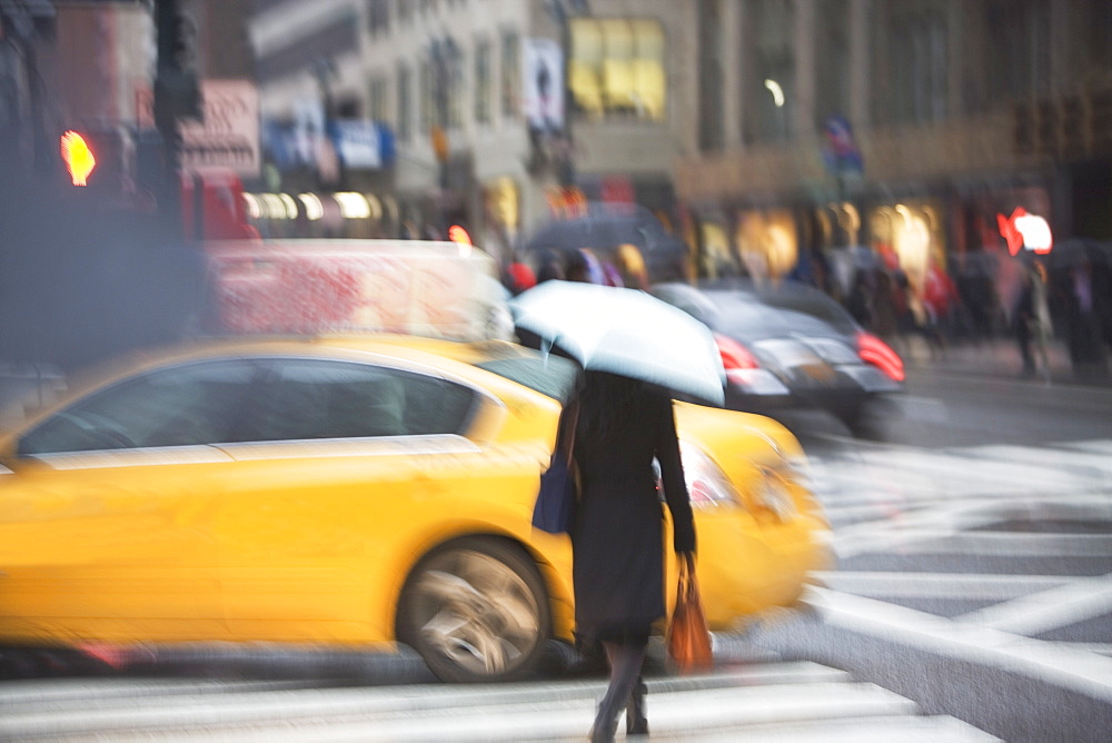 USA, New York state, New York city, pedestrian with umbrella on zebra crossing 