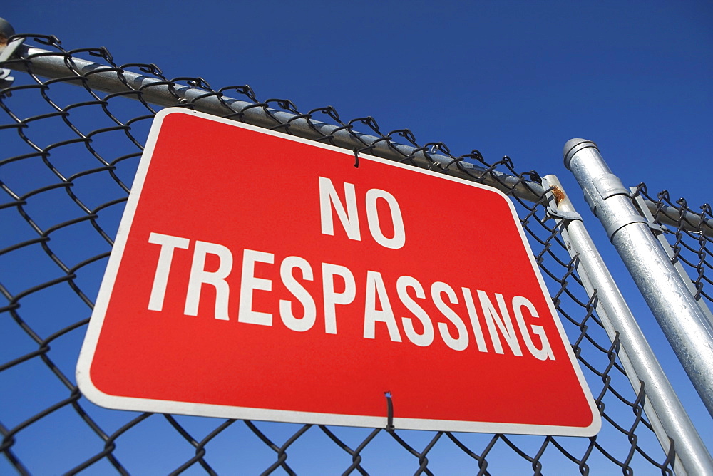 Low angle view of no trespassing sign