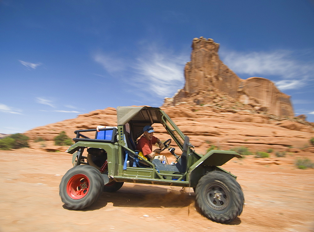 Man driving off-road vehicle in desert