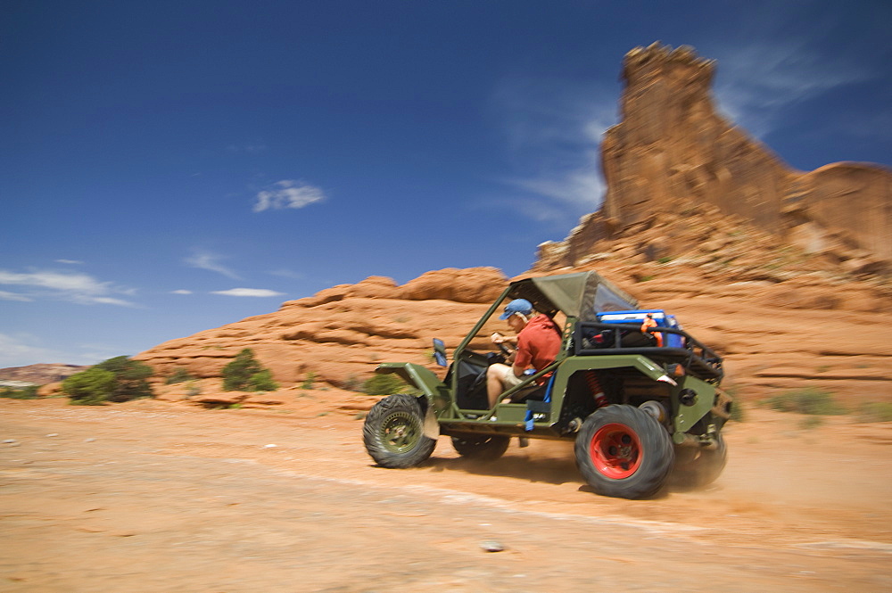 Man driving off-road vehicle in desert