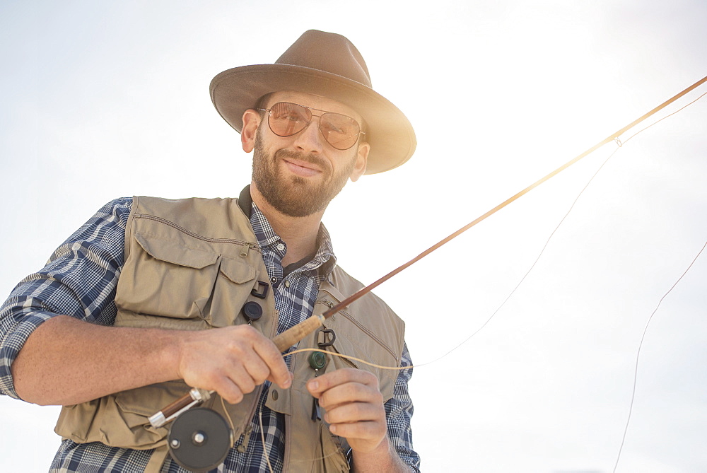 Portrait of man holding fishing rod