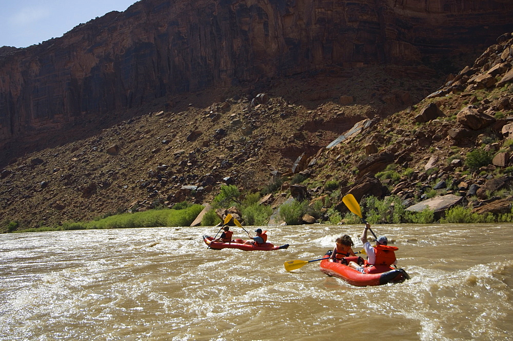 People paddling in rafts