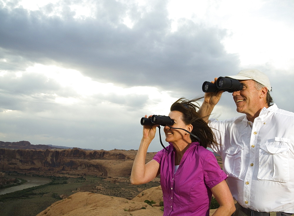 Couple looking through binoculars