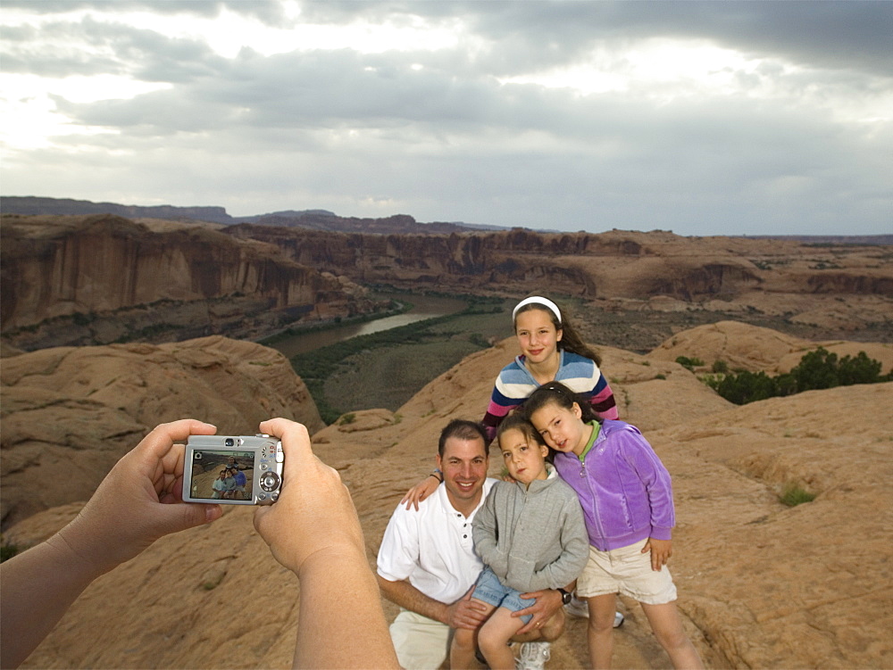 Father and daughters having photograph taken