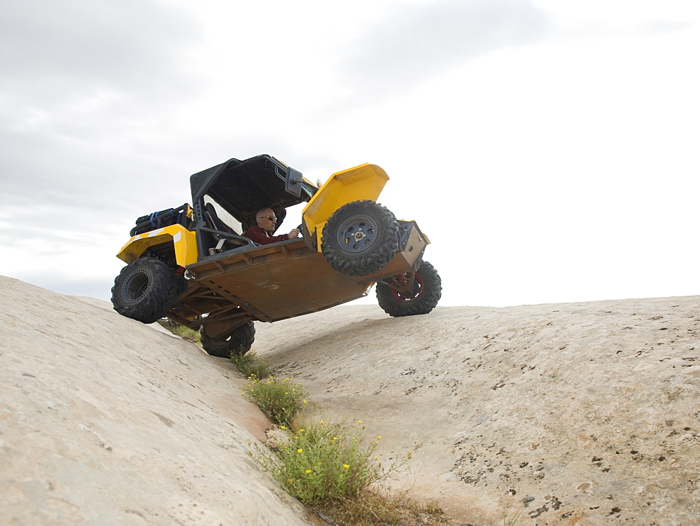 People in off-road vehicle on rock formation