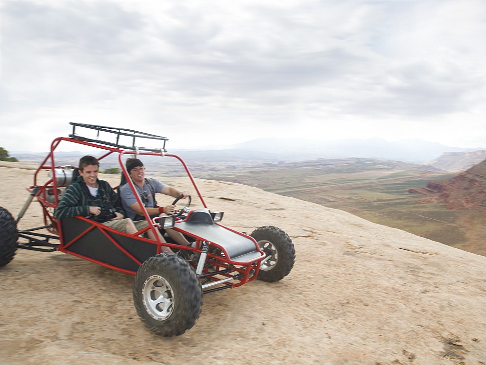 People in off-road vehicle on rock formation