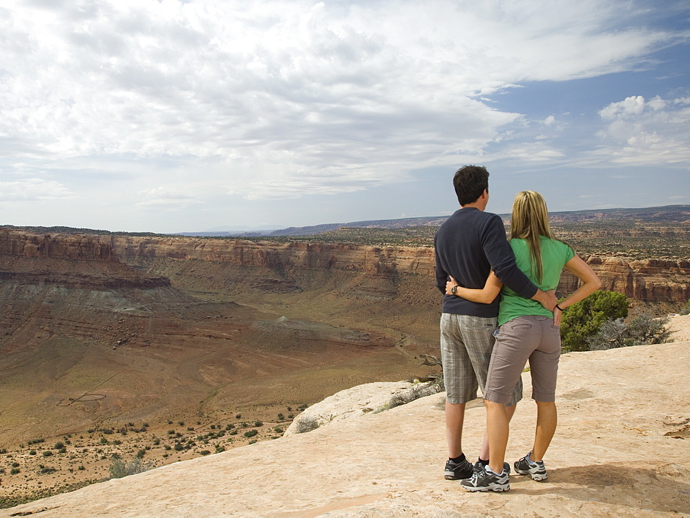 Couple looking over edge of cliff