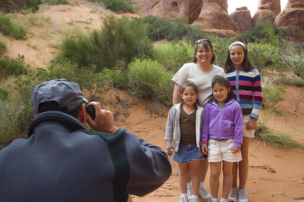 Father taking photograph of family