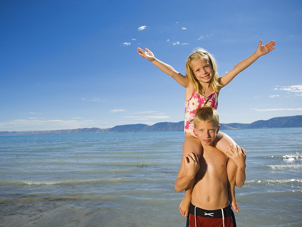 Girl sitting on brotherâ€™s shoulders, Utah, United States