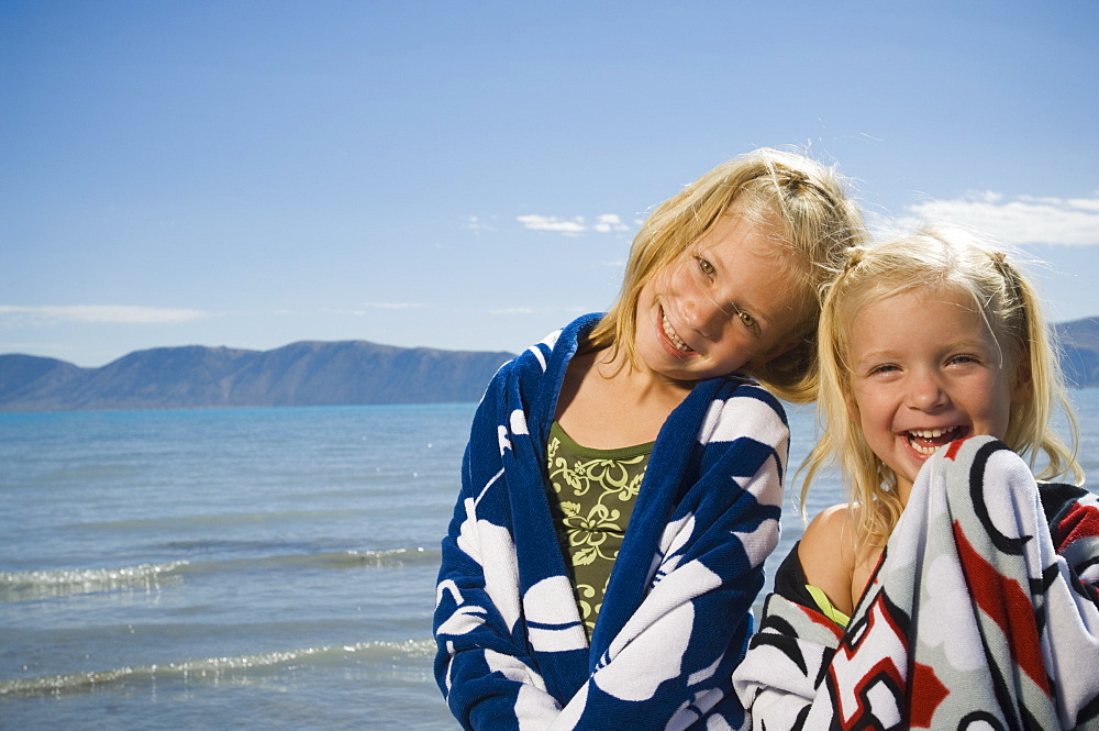 Sisters wrapped in beach towels, Utah, United States