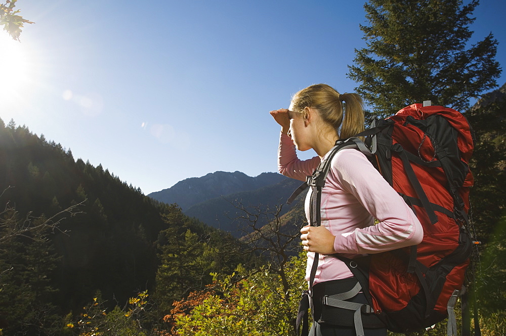 Female hiker shielding eyes with hand, Utah, United States