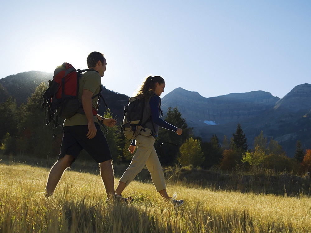 Couple hiking with backpacks, Utah, United States