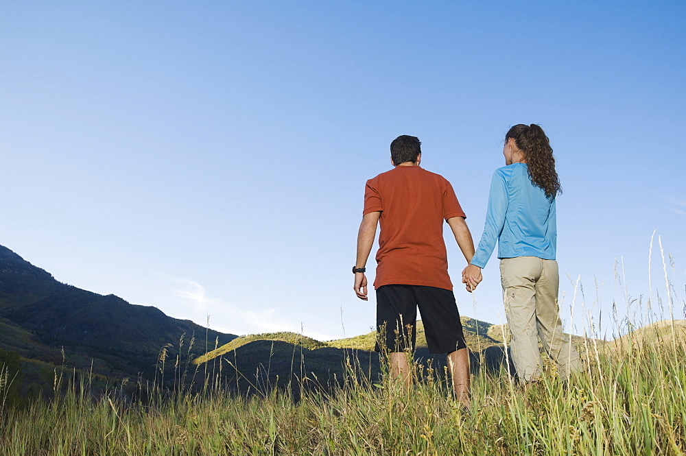 Rear view of couple holding hands, Utah, United States