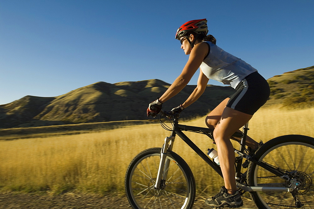 Woman riding mountain bike, Salt Flats, Utah, United States