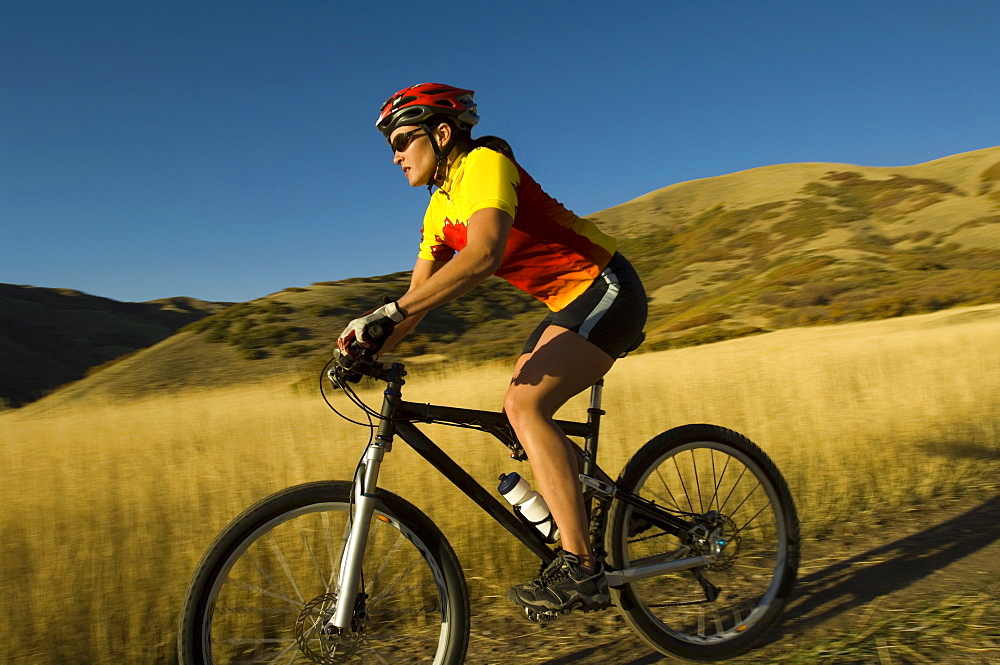 Woman riding mountain bike, Salt Flats, Utah, United States