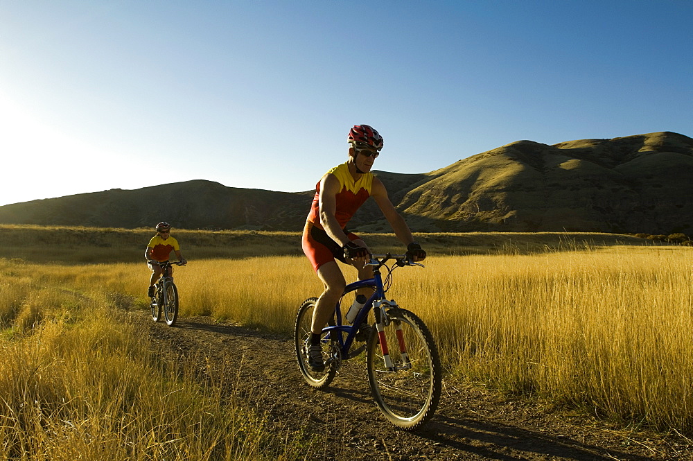 Couple riding mountain bikes, Salt Flats, Utah, United States