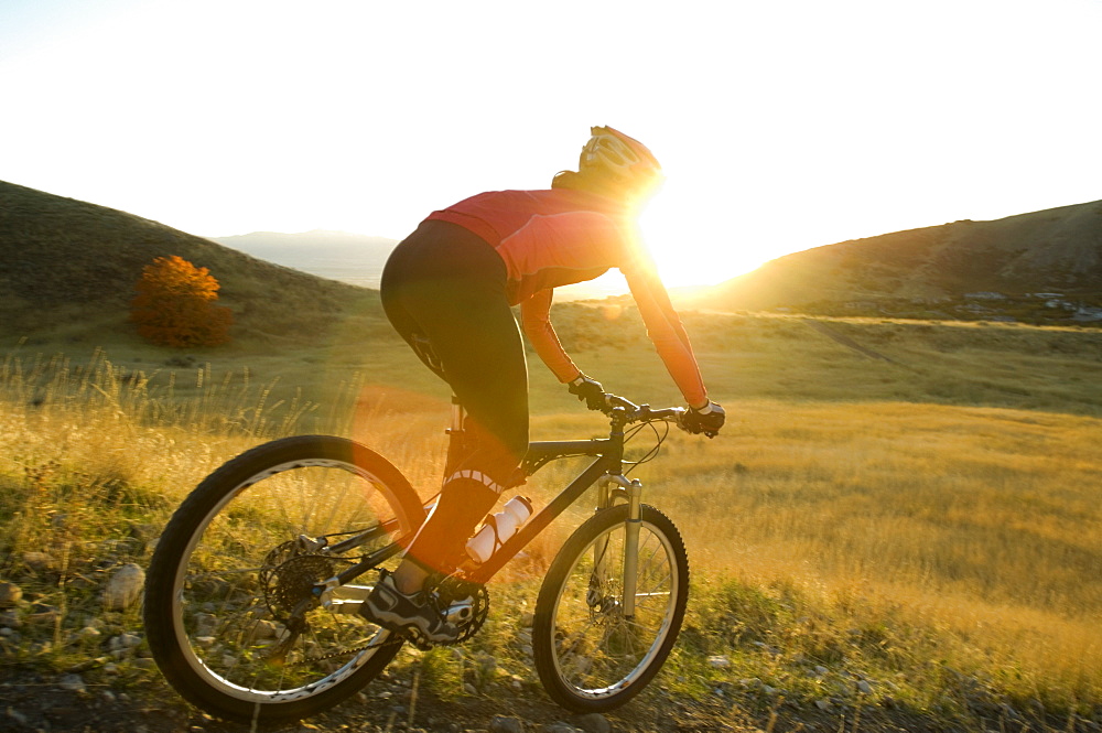 Woman riding mountain bike, Salt Flats, Utah, United States