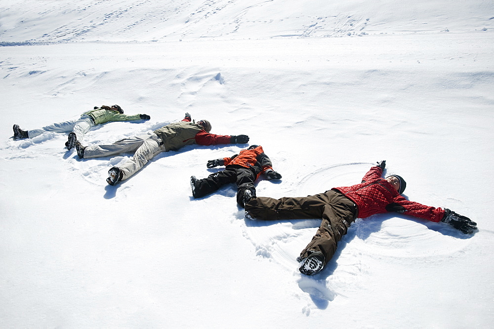 Family making snow angels