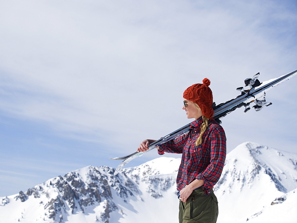 Woman holding skis on shoulder