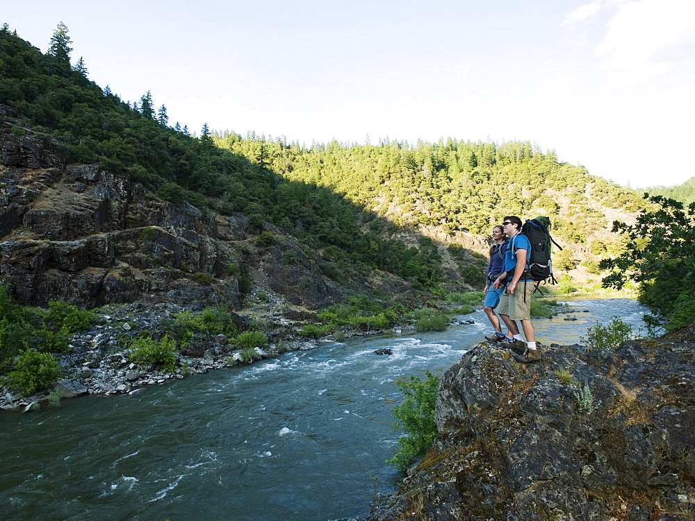 Hikers admiring view of river