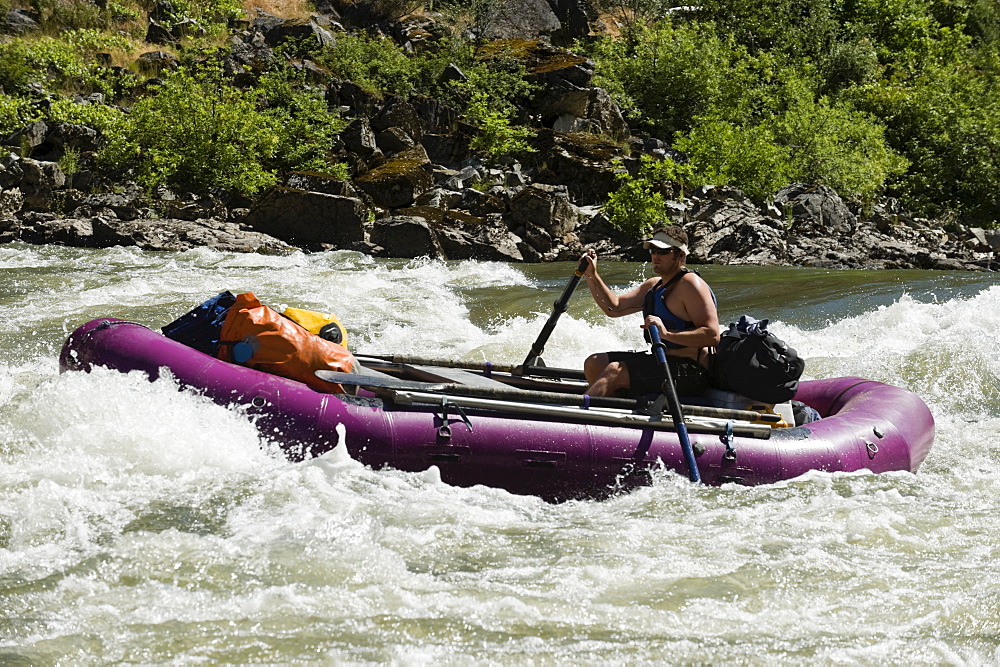 Man whitewater rafting