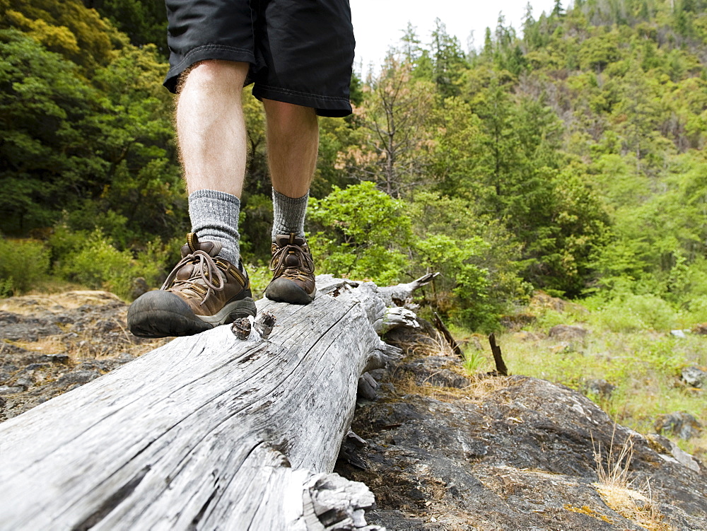 Hiker balancing on log