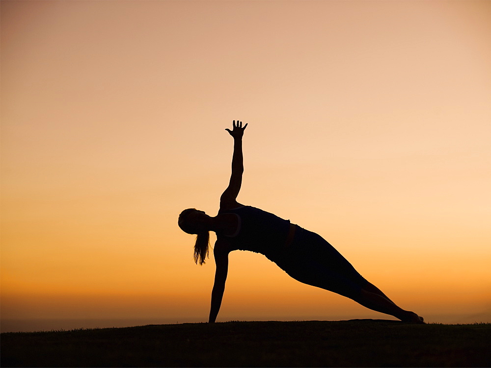 Silhouette of woman doing yoga