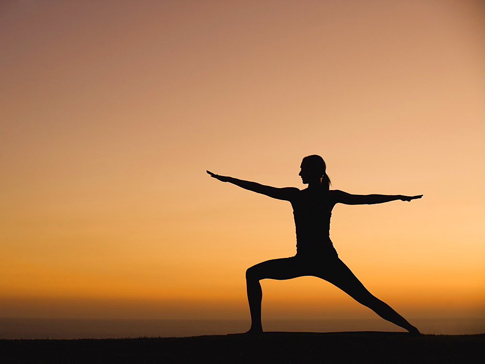 Silhouette of woman doing yoga