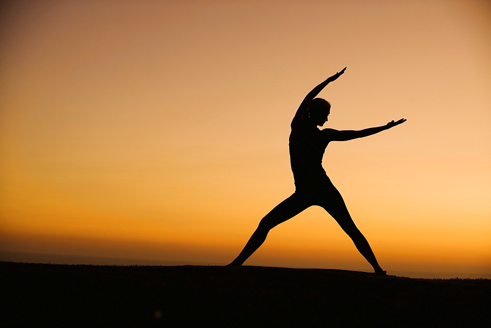 Silhouette of woman doing yoga