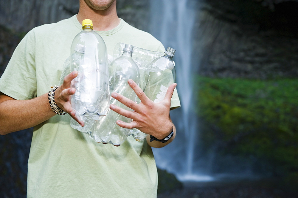 Man holding empty water bottles