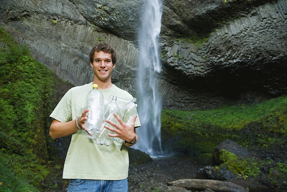 Man holding empty water bottles