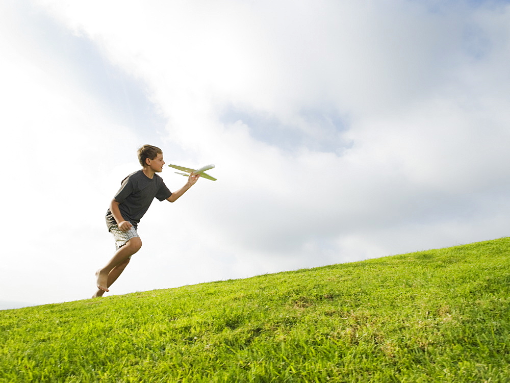 Boy playing with toy airplane