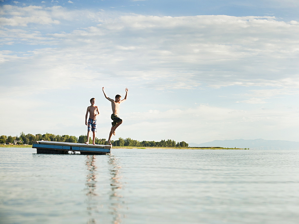 Boys (10-11,12-13) jumping from raft