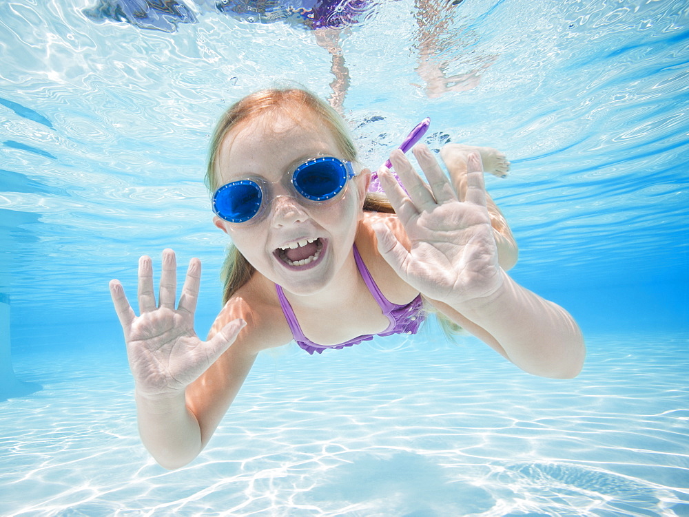 Girl (6-7) swimming underwater