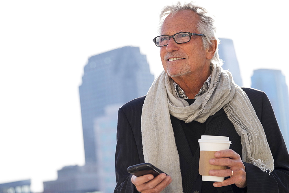Man in street with coffee and smartphone