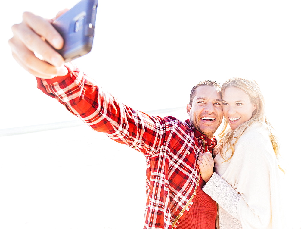 Couple taking selfie on beach