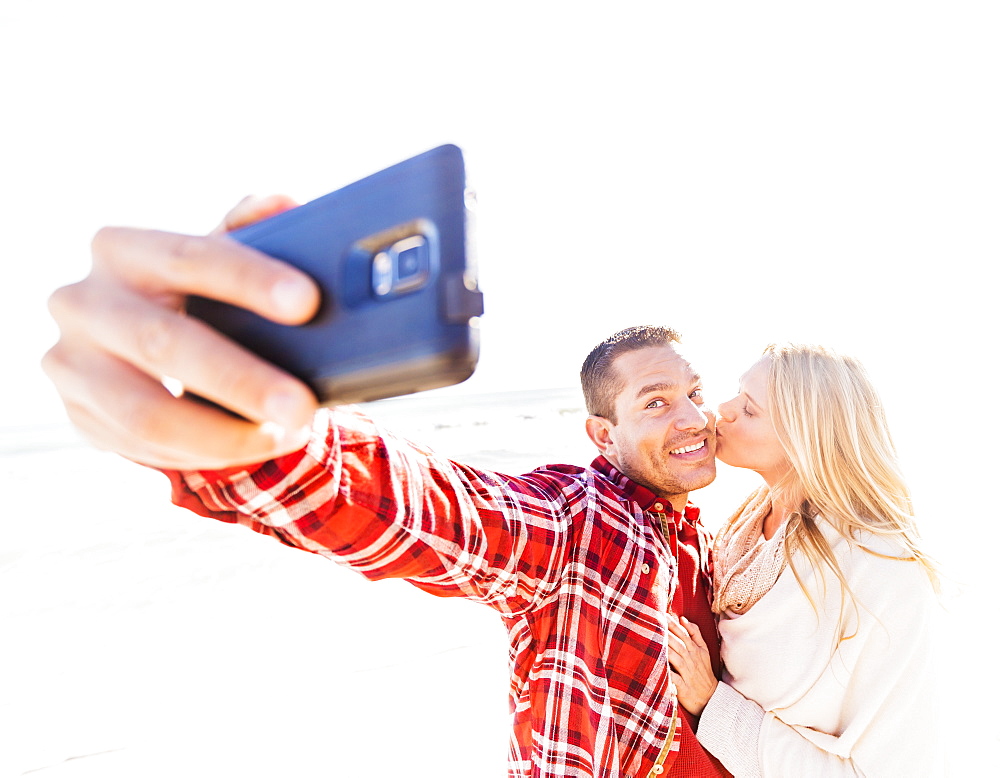 Couple taking selfie on beach